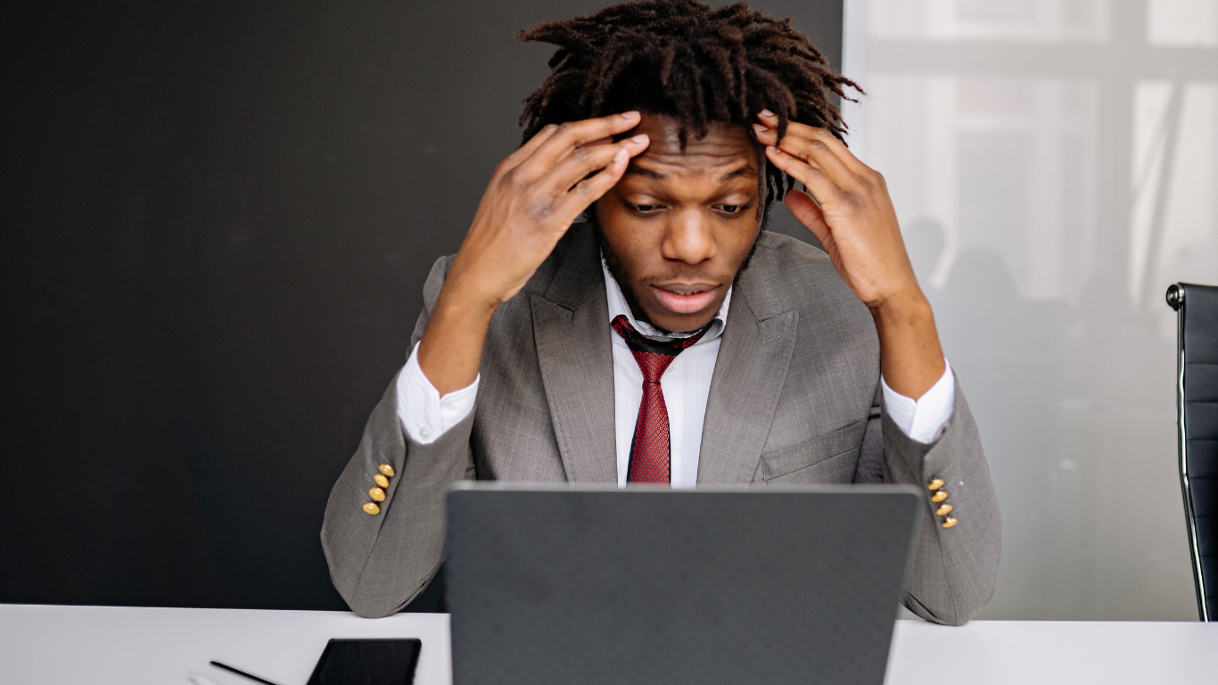 Business owner looking stressed at negative reviews: Online Reputation Management